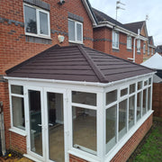 An image of an Edwardian Conservatory with Lightweight Metal Roof Shingles in Bramble Brown