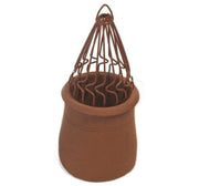 An image of a sprung bird guard in Terracotta by MAD Cowls fitted into a chiney pot to show how they look when fitted.