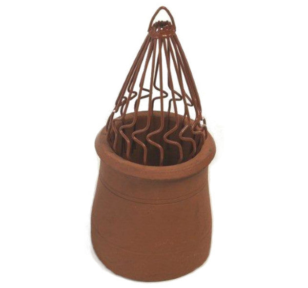 An image of a sprung bird guard in Terracotta by MAD Cowls fitted into a chiney pot to show how they look when fitted.