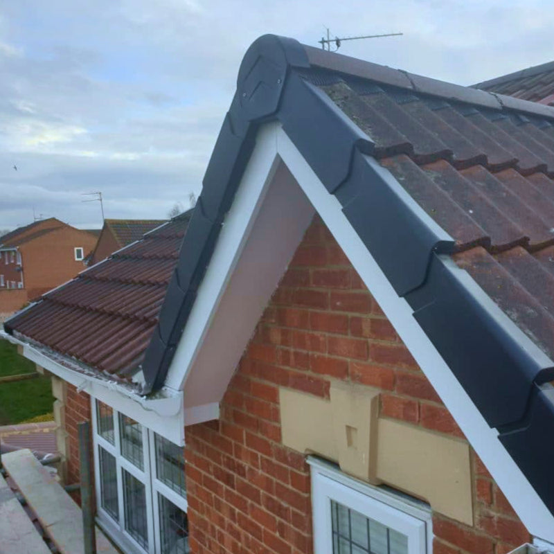 An image of Manthorpe GDV Half Round End Cap Grey on the side of a roof to show what it looks like.