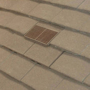 An image of Manthorpe Granulated Plain Tile Vent in Antique Brown on a roof to show the finish.