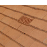 An image of Manthorpe Granulated Plain Tile Vent in Sand Red on a roof to show the finish.