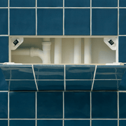 An image of a Manthorpe Tile Access Panel GLTAP-500 being used to cover pipes and covered with blue tiles