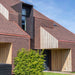 An image of a roof and walls fitted with Marley Concrete Plain Tiles to show what they look like.