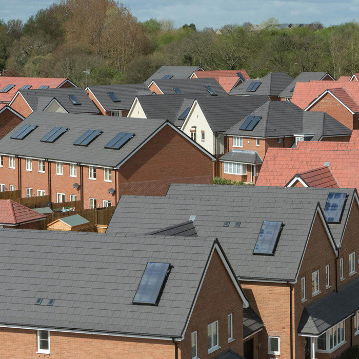 An image of several houses all fitted with different colour Marley Edgemere Interlocking Slates to show what it looks like.