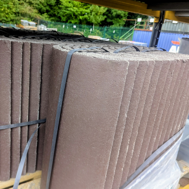 An image of Marley Moderns Segmental Ridge Tiles in Smooth Brown stacked on a Pallet