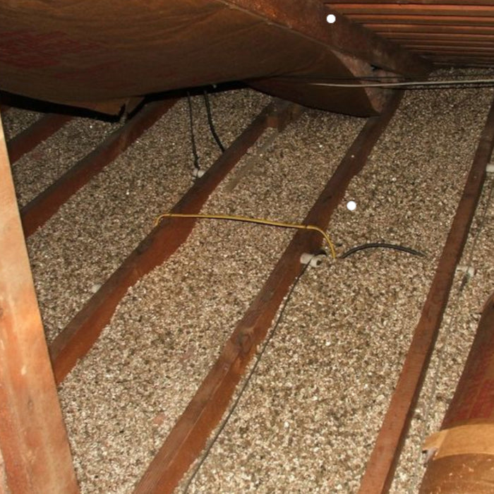 Image shows a loft / attic / Roof Space with  Micafil Vermiculite Loose Fill used as insulation.