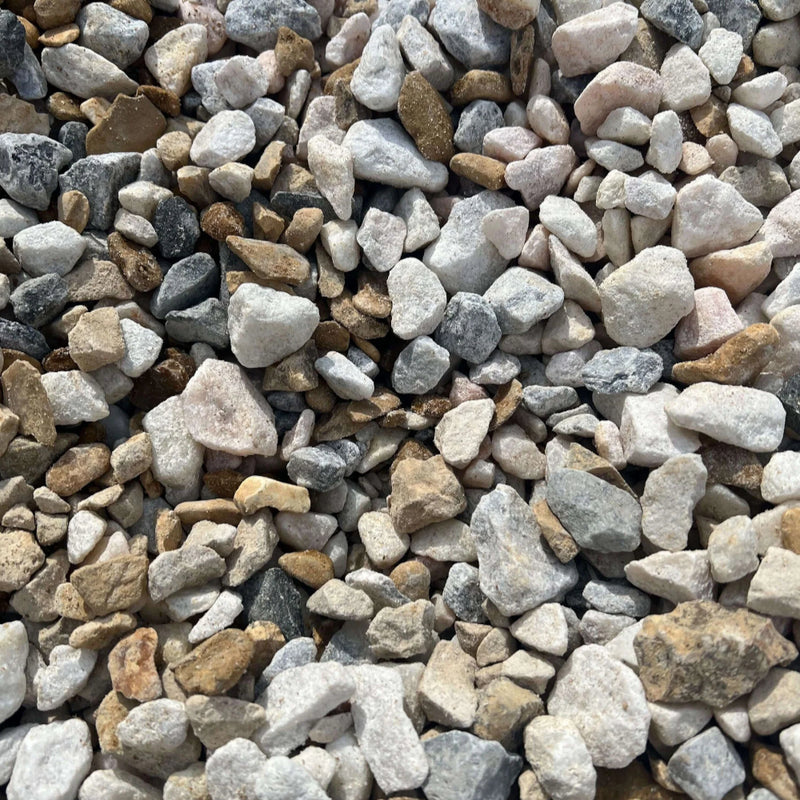 An image of Mixed Stone Chippings between 10mm and 20mm in size. Including White Limestone, Cotswold Buff, Golden Gravel, Black Ice, Red Granite, Polar White, Polar Ice, Ice Blue, Flamingo.