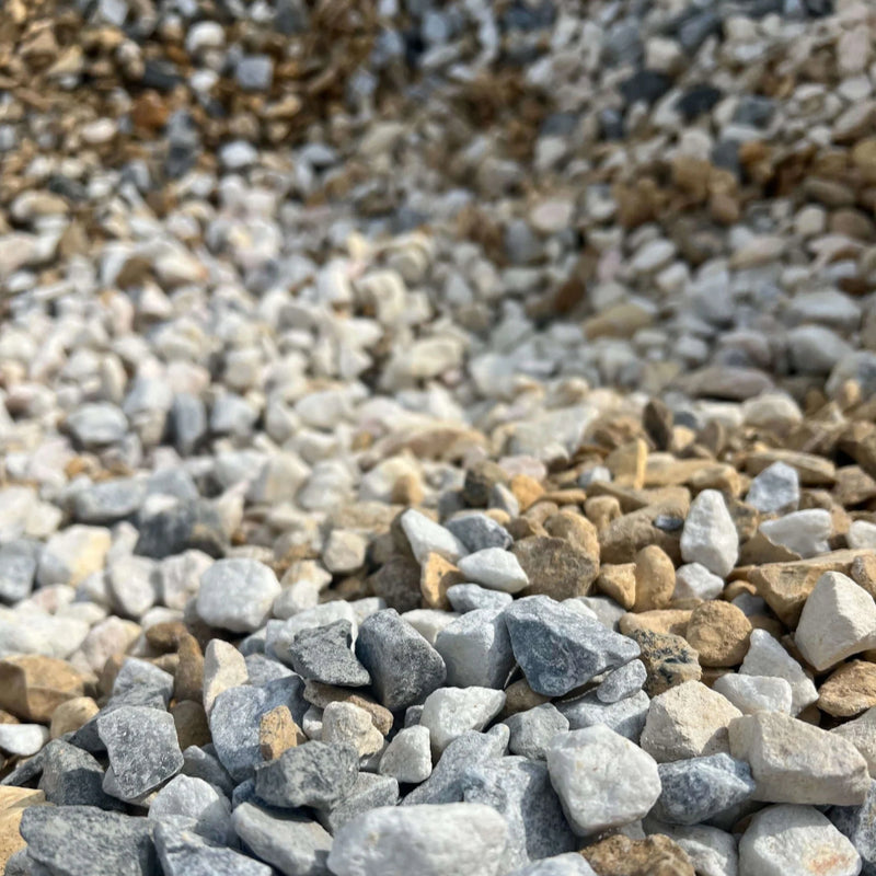 An image of Mixed Stone Chippings between 10mm and 20mm in size. Including White Limestone, Cotswold Buff, Golden Gravel, Black Ice, Red Granite, Polar White, Polar Ice, Ice Blue, Flamingo.