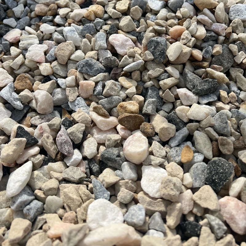 An image of Mixed Stone Chippings between 10mm and 20mm in size. Including White Limestone, Cotswold Buff, Golden Gravel, Black Ice, Red Granite, Polar White, Polar Ice, Ice Blue, Flamingo.