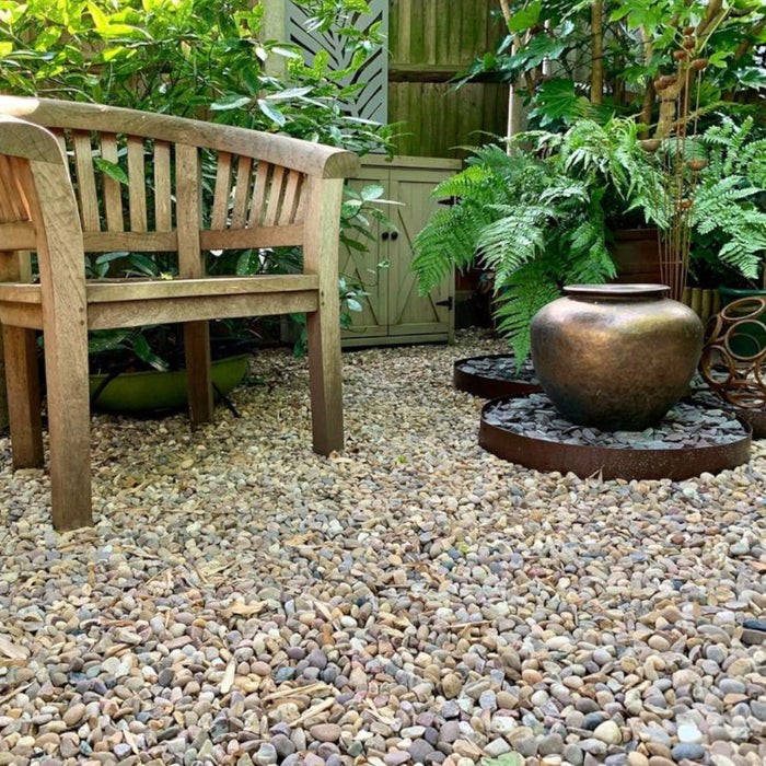 An image of Pea gravel and how they look when laid in a garden patio