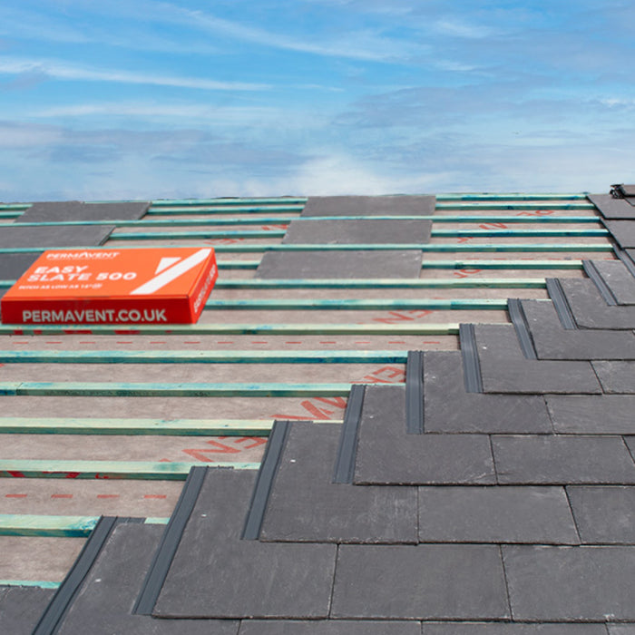 An image of Permavent Easy Slate low roof pitch system being used under a slate to show where they are fitted.