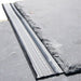 An image of Permavent Easy Slate low roof pitch system being used under a slate to show where they are fitted.