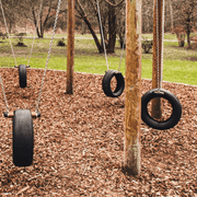 Image of Children's Play bard wood chippings.  They are brown tones and the image shows them laid out in a playground to show the effect