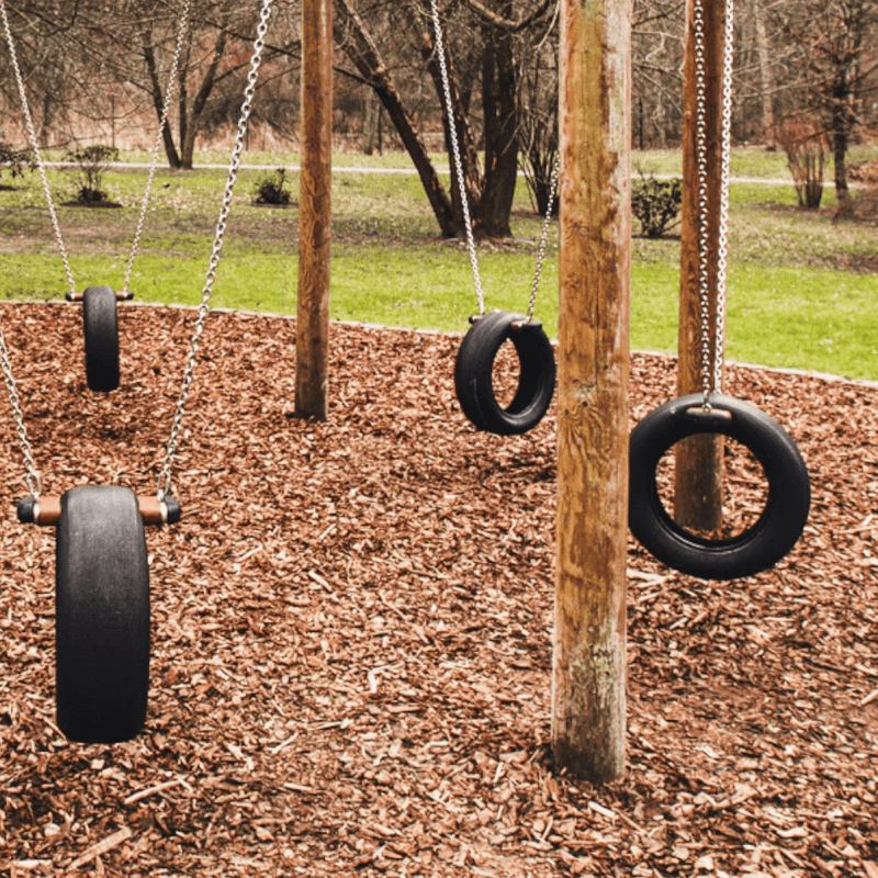 Image of Children's Play bard wood chippings.  They are brown tones and the image shows them laid out in a playground to show the effect