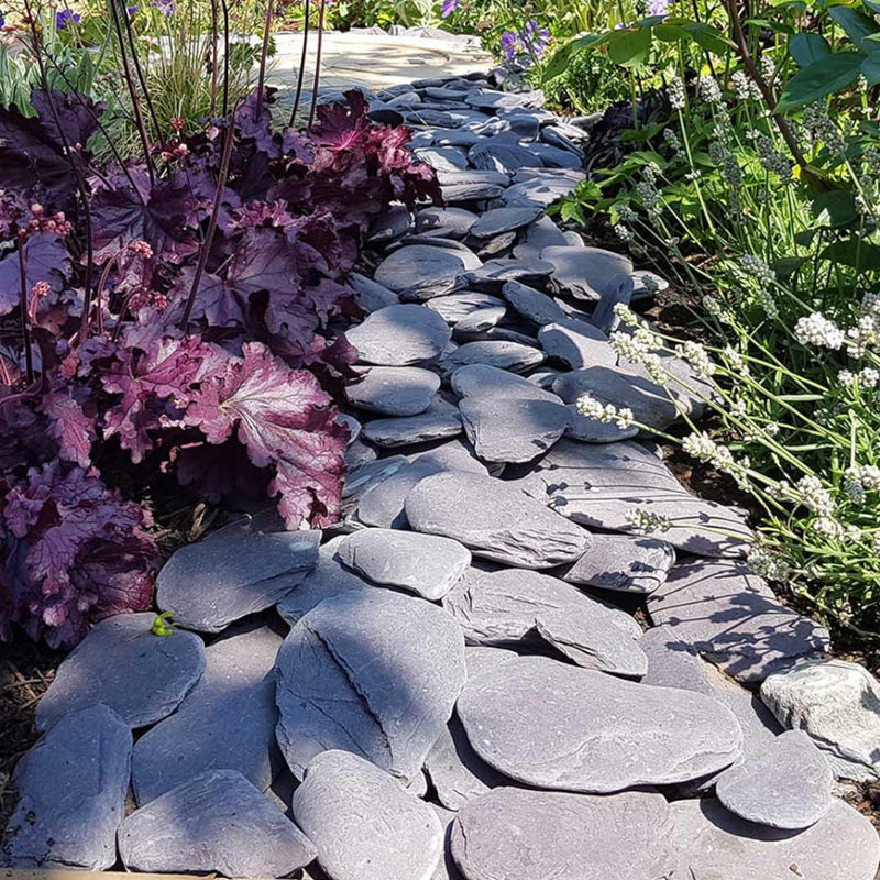 An aggregate image of Plum Slate paddle stones laid as a path to show what they look like wen dry.