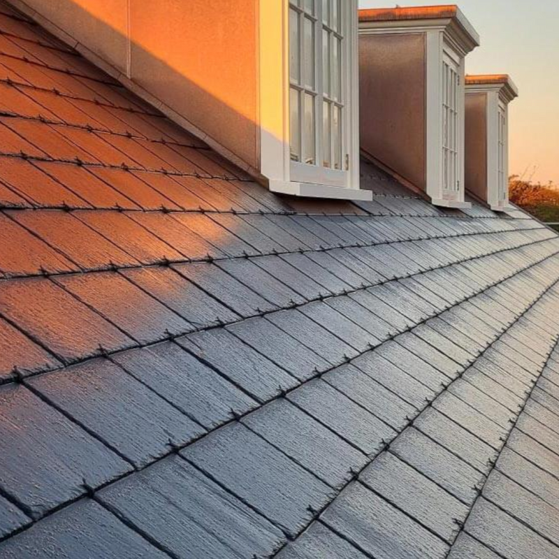 An image showing slates on a roof held in place with Point Driven Slate Hooks Black-Coated to show what they look like.