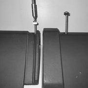 An image showing a Premium Clay Universal Angle Capped Ridge 90 / 135 Degree in Black and how they are fixed and secured to a roof.