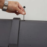 An image showing a Premium Clay Universal Angle Capped Ridge 90 / 135 Degree in Black and how they are fixed and secured to a roof.