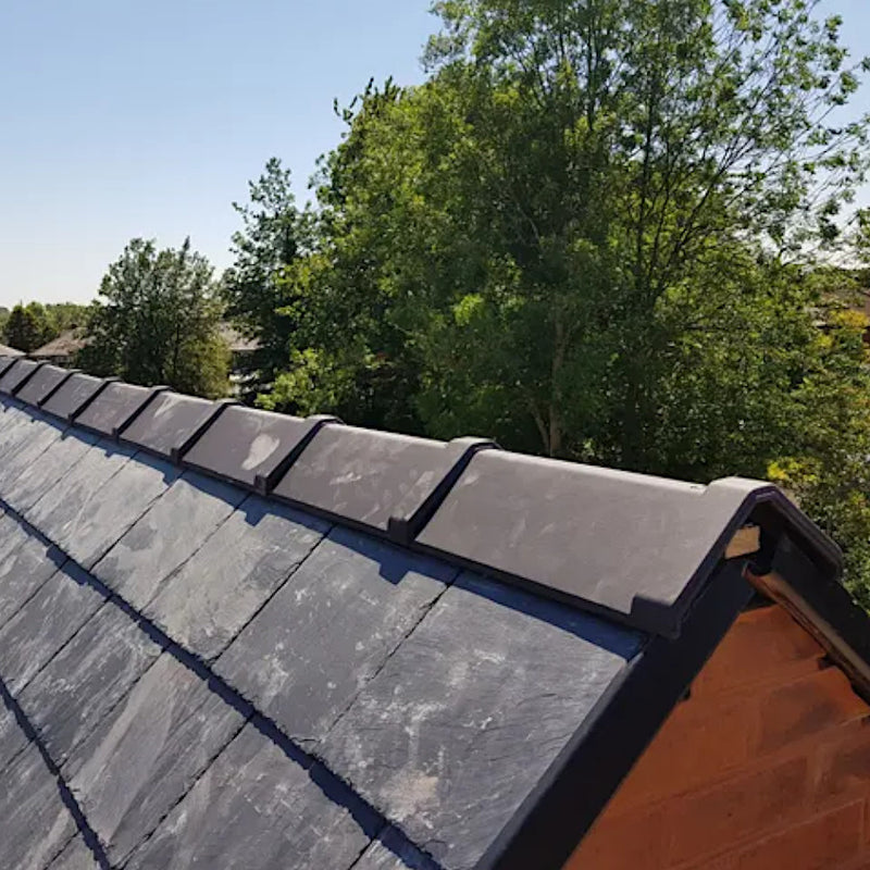 An image showing Premium Clay Universal Angle Capped Ridge 90 / 135 Degree in Black installed onto a roof to show what it looks like.