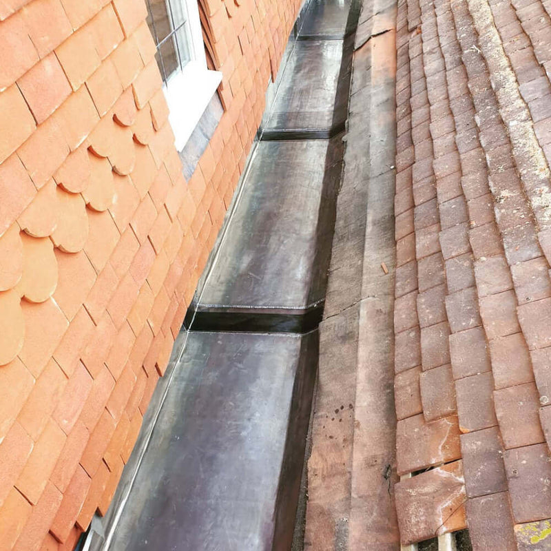An image of Premium Lead expansion joints with a Black flexible middle being used on a roof