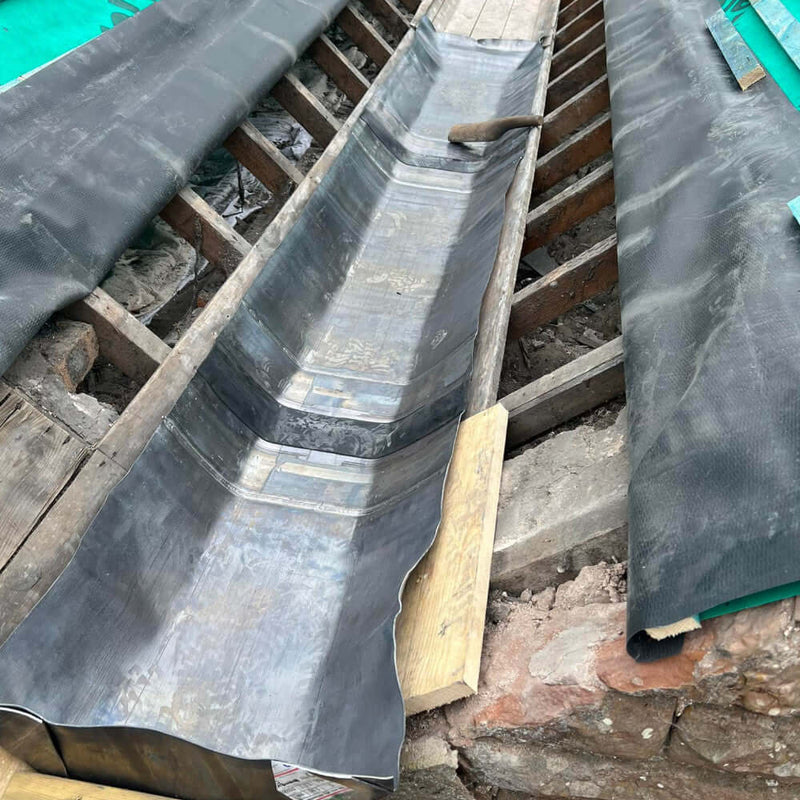 An image of Premium Lead expansion joints with a Black flexible middle being used on a roof