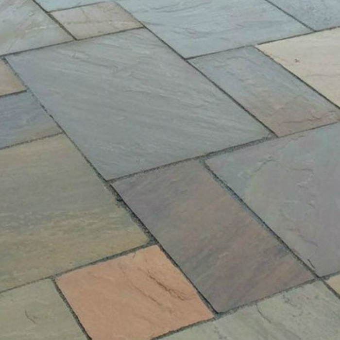 An image of Raj Green Indian Standstone Paving laid out to show what it looks like wet.