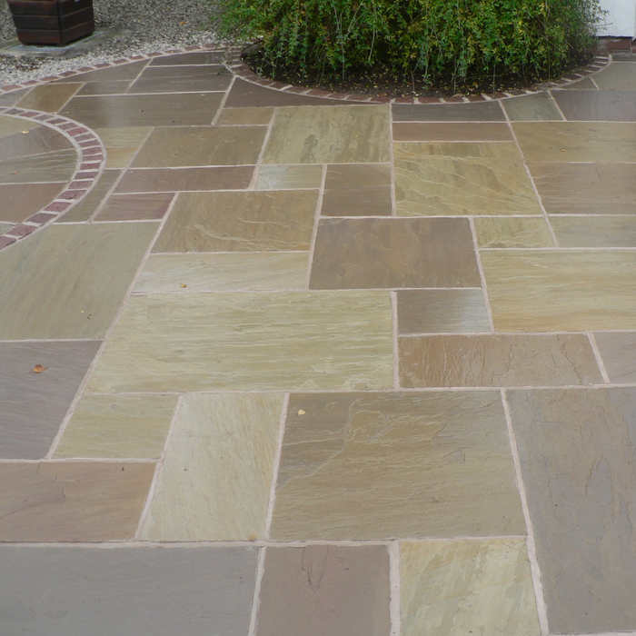 An image of Raj Green Indian Standstone Paving laid out to show what it looks like damp.