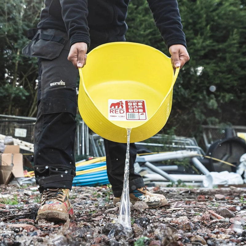 Image of a Red-Gorilla Small Shallow Tub Yellow with a 15 litre capacity being used to move and pour away water.