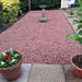 An image of Red Granite Gravel Bulk Bag shown when laid down in a garden