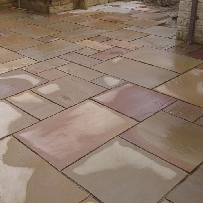 Am image of Rippon Buff Indian Sandstone Paving laid out to show how it looks when wet.