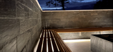 An image of the Riverstone Natural Slate Cladding stone  on the inside of a wall with a bench attached.