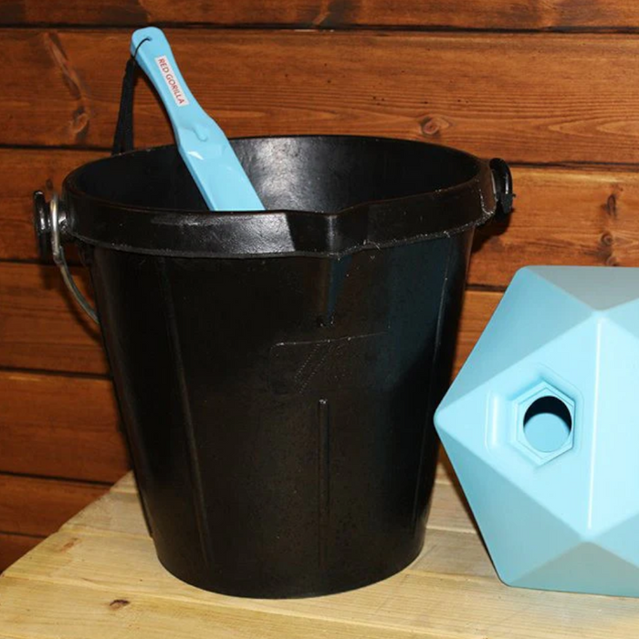 An image of a black Heavy Duty Rubber Bucket made from type rubber. It is against a wooden background in use.