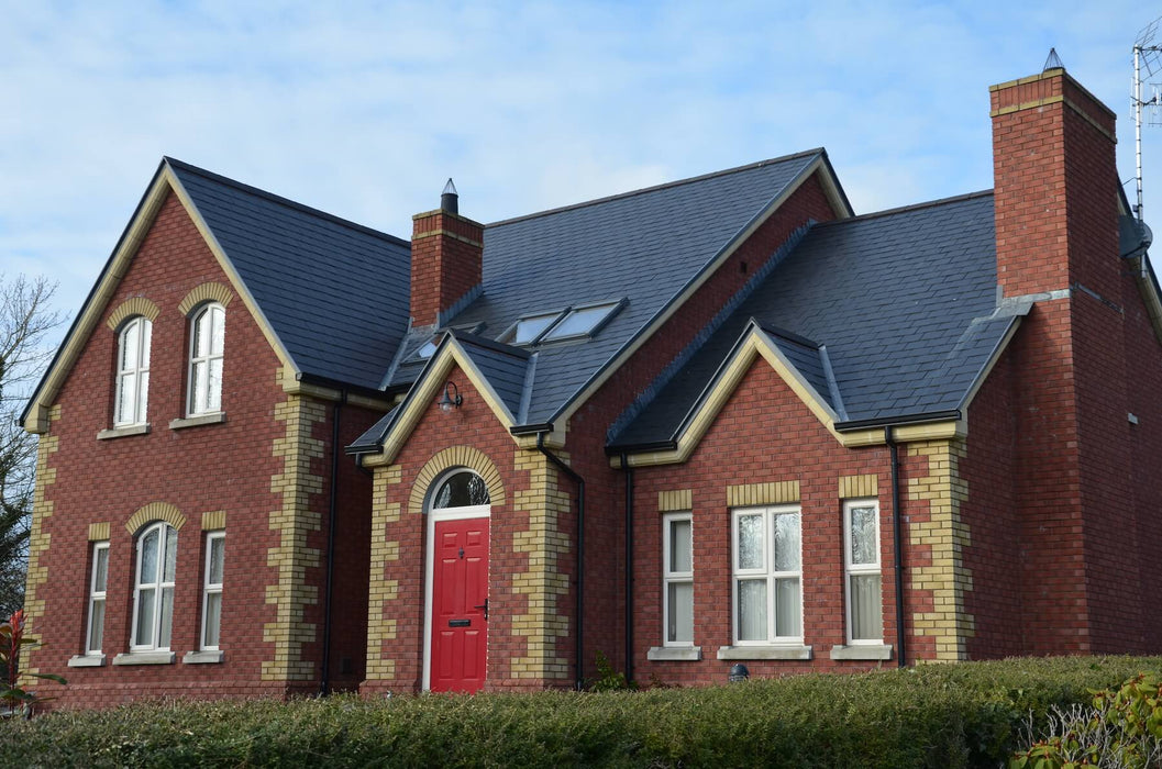 An image of a house with SSQ Del Carmen Ultra slate tiles on them to show the finish