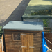 An image of a roll of Green Rose Roofing Shed Felt fitted and installed onto a shed roof.