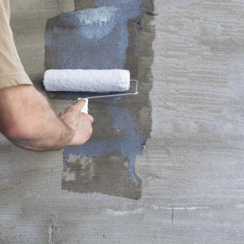 An image of Sika Contrators pva admixture being applied to a plastered surface with a roller.