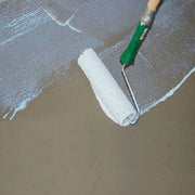 An image of SikaBond SBR Waterproofer & Bonding Admixture being to a surface with a roller.
