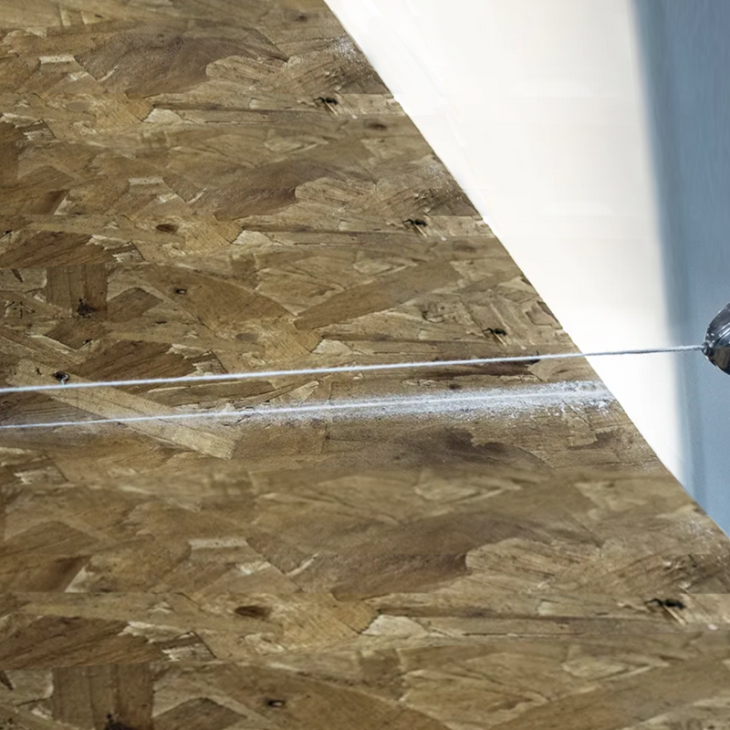 An image showing the Stanley Chalk Line in white on OSB board