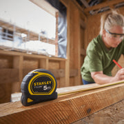 An image of a Stanley Tylon Tape Measure that is being used to measure timber
