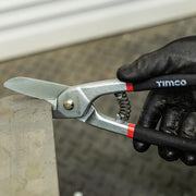 An image of TIMCO Tin Snips being used to cut tin metal.