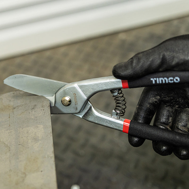 An image of TIMCO Tin Snips being used to cut tin metal.