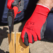An image showing TIMCO toughlight gloves being used to chop wood with an axe to protect hands.