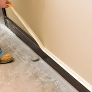 An image showing TMICO 50 x 50 cream masking tape being used to mask up skirting boards.