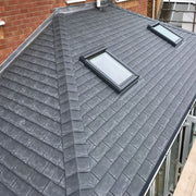 An image of a TapcoSlate Synthetic Hip and Ridge in Pewter Grey on a roof to show how they look.