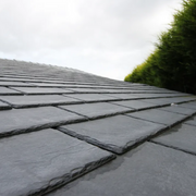 A roof with Tapco Classic Synthetic Roof Slate in Pewter Grey fitted to show what they look like