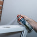 An image of Timco Adhesive Residue Remover being used on the edge of a window frame.