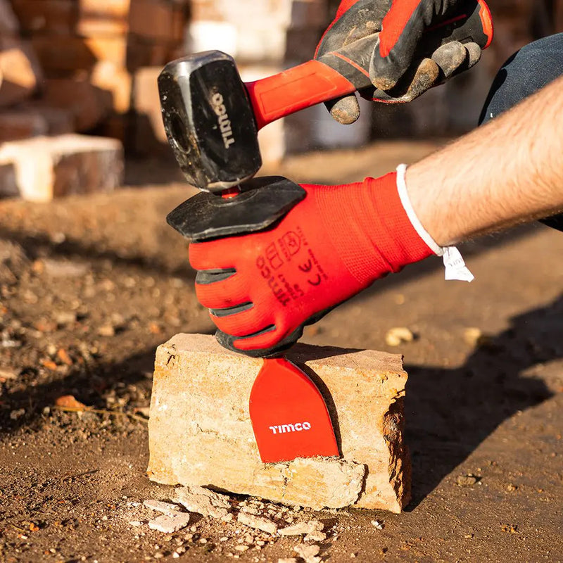 An image of a Timco Lump Hammer being used on a bolster to trim down some stone