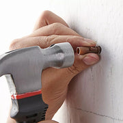 An image showing Timco Premium Plastic Rawl Wall Plugs Brown 42mm being tapped into a pre-drilled hole with a hammer ready for a screw.
