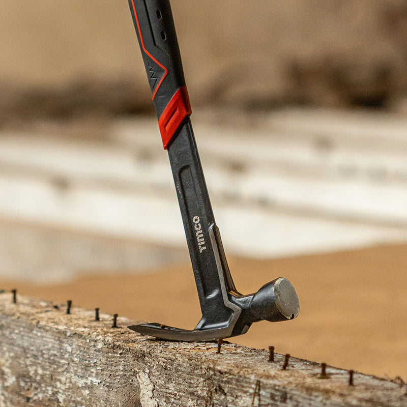An image of a Timco Proffesional Claw Hammer, in the image it is removing rusted nails from wood.