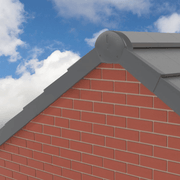 An image of a Universal dry fix half round ridge end cap in Grey fixed to the verge of a roof to show what it looks like.
